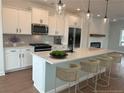 Modern kitchen featuring a large island, stainless steel appliances, and white cabinetry at 1915 Cassia Aly, Kennesaw, GA 30144