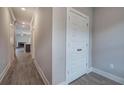 Hallway showing a linen closet and a view into the living room and fireplace at 201 Daisy Coourt, Cartersville, GA 30121