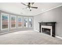 Inviting living room with a fireplace, carpeted floors, and large windows offering natural light at 1168 Christiana Xing, Lawrenceville, GA 30043