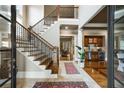 Grand foyer featuring a staircase with iron railings and hardwood floors at 415 Prestwick Ct, Alpharetta, GA 30005