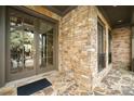 Inviting front porch with stone accents, double doors and elegant lighting at 415 Prestwick Ct, Alpharetta, GA 30005