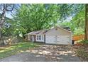 A cozy single story home with stone facade, light beige siding, and a two car garage at 971 Clover Ln, Lawrenceville, GA 30044