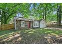 Charming single-story home featuring a stone facade, bright red front door, and a well-maintained lawn at 971 Clover Ln, Lawrenceville, GA 30044