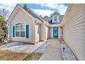 Well-lit front entrance with a blue glass door and decorative stone landscaping at 1020 Adie Cv, Mcdonough, GA 30253