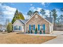 Attractive single-story home featuring a stone facade, well-kept lawn, and a two car garage at 1020 Adie Cv, Mcdonough, GA 30253