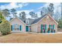 Inviting ranch-style home with a blue front door, stone accents, and well-maintained yard at 1020 Adie Cv, Mcdonough, GA 30253