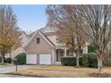 Two-story brick and siding home featuring an attached two-car garage and a covered front porch at 1312 Preserve Park Dr, Loganville, GA 30052