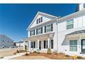 Charming two-story home features white siding, black shutters and tasteful landscaping at 1703 Prospect Way, Conyers, GA 30094
