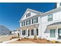 Close-up view of a charming two-story home with black shutters and white siding at 1703 Prospect Way, Conyers, GA 30094