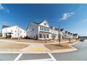 A street view shows a row of beautiful white homes in a well-planned community at 1703 Prospect Way, Conyers, GA 30094