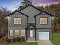 Charming two-story home with gray siding, black trim, white garage door, and a well-manicured lawn at 3195 Tackett Rd, Douglasville, GA 30135