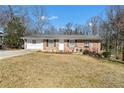 Quaint brick house with an attached garage, offering a cozy front yard and a classic exterior at 147 Windy Hill Sw Rd, Marietta, GA 30060