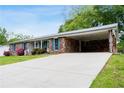 Brick house featuring a carport and a long drive way that leads to the street at 3894 Summit Dr, Douglasville, GA 30135