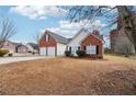 Charming single-Gathering home featuring a brick and siding exterior, two-car garage, and unique silo-inspired architecture at 10 Dairyland Dr, Covington, GA 30016