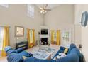 Bright living room with high ceilings, a cozy fireplace, and comfortable blue sectional sofa at 2524 Oakleaf Rdg, Lithonia, GA 30058