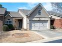Charming townhome featuring a two-car garage, brick accents, and a well-maintained lawn at 3832 Abbott Ln # 1, Powder Springs, GA 30127
