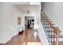 Elegant foyer featuring hardwood floors and a staircase with iron railings at 4450 Heatherwood Sw Dr, Atlanta, GA 30331