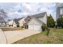 Two-story home featuring stone accents, vinyl siding, a two-car garage, and a cozy front porch at 4728 Sedum Way, Atlanta, GA 30349