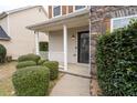 Close-up of the welcoming front porch with stone accents and manicured landscaping at 4728 Sedum Way, Atlanta, GA 30349