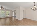 Bright living room featuring hardwood floors, large windows, and an open archway at 4728 Sedum Way, Atlanta, GA 30349