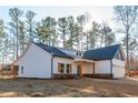 Angle view of new home with a two car garage, front covered porch and a blue gable at 30 Sportsman Path, Dallas, GA 30157