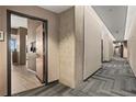 A well-lit hallway with patterned carpet leading to residential units at 361 17Th Nw St # 807, Atlanta, GA 30363
