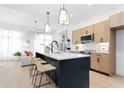 Bright kitchen with modern island, pendant lighting, stainless appliances, and hardwood flooring at 567 Ponce De Leon Ne Ave # 510, Atlanta, GA 30308