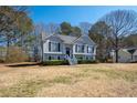 Charming two-story home with well-maintained landscaping, elegant gray siding, and mature trees at 169 Bethnal Way, Douglasville, GA 30134