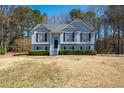 Charming two-story home with manicured lawn, elegant gray siding and well-maintained landscaping at 169 Bethnal Way, Douglasville, GA 30134