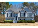 Charming two-story home with elegant gray siding, well-maintained landscaping, and inviting entrance at 169 Bethnal Way, Douglasville, GA 30134