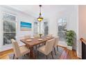Dining room with a hardwood floor, natural light, crown moulding, and a view of a beach painting at 2428 Crescent Park Ct, Atlanta, GA 30339