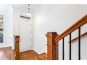 Bright foyer featuring hardwood floors, white walls, staircase with a wooden railing, and natural light at 2428 Crescent Park Ct, Atlanta, GA 30339