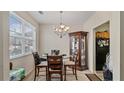 Bright dining area with a round glass table and stylish chandelier fixture at 6327 Ellenwood Dr, Rex, GA 30273