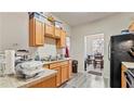 Efficient kitchen with ample cabinetry, and a convenient access to the dining area at 6327 Ellenwood Dr, Rex, GA 30273