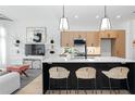 Stylish kitchen island with modern pendant lights and open shelving at 567 Ponce De Leon Ne Ave # 614, Atlanta, GA 30308