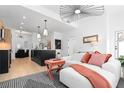 Cozy living room open to a modern kitchen with an island and bar stools at 567 Ponce De Leon Ne Ave # 614, Atlanta, GA 30308
