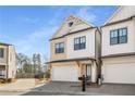 Beautiful two-story home featuring a two-car garage, dark window trim, and lovely exterior finishes at 685 Stickley Oak Way, Woodstock, GA 30189