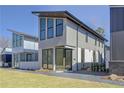 Modern two-story home featuring large windows, sleek design, and well-manicured lawn at 115 Arcadia Ave, Fayetteville, GA 30214