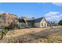 Landscaped yard with a charming home, showcasing its exterior features on a sunny day at 128 Graybrook Ct, Grayson, GA 30017