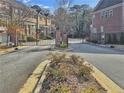 Gated community entrance with brick pillars and manicured landscaping at 1690 Mosaic Way, Smyrna, GA 30080