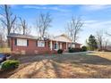 Charming brick home with a covered porch, black shutters, and a well-maintained lawn at 19 Roving Rd, Cartersville, GA 30121