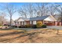 A brick house with a nice yard and covered parking area next to the house at 19 Roving Rd, Cartersville, GA 30121