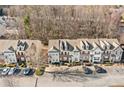 Overhead view showcasing a townhouse community with parking, surrounded by trees at 1331 Penhurst Dr, Lawrenceville, GA 30043