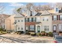 Attractive exterior view of townhouses featuring manicured front yard landscaping and convenient parking at 1331 Penhurst Dr, Lawrenceville, GA 30043