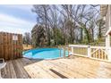 Backyard in-ground pool with wooden deck, perfect for summer relaxation and outdoor entertainment at 134 Turman Se Ave, Atlanta, GA 30315