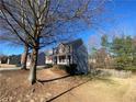 Two-story home featuring a brick facade, siding, and covered porch, set in a tree-lined neighborhood at 2124 Mitford Ct, Dacula, GA 30019