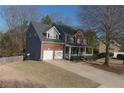 Attractive two-story home with brick and siding, a two-car garage, and a well-maintained lawn at 2124 Mitford Ct, Dacula, GA 30019