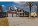 Inviting two-story brick home featuring a covered front porch and convenient two-car garage at 2124 Mitford Ct, Dacula, GA 30019