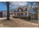 A lovely two-story brick home with a welcoming porch and well-kept front yard at 2124 Mitford Ct, Dacula, GA 30019