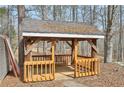 Rustic wooden gazebo with covered roof, located in a wooded backyard area offering a relaxing outdoor space at 4009 Highway 138 Sw, Stockbridge, GA 30281